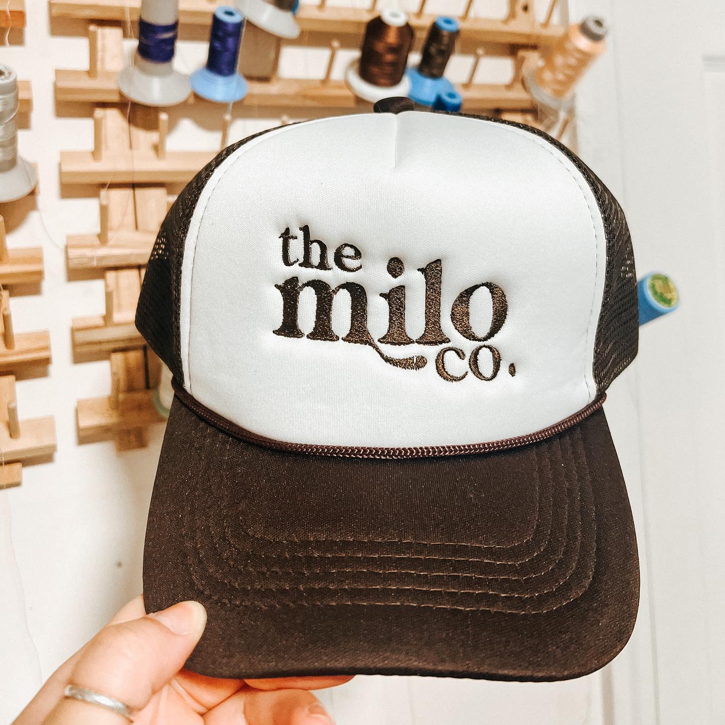 the milo co embroidered black and white trucker hat