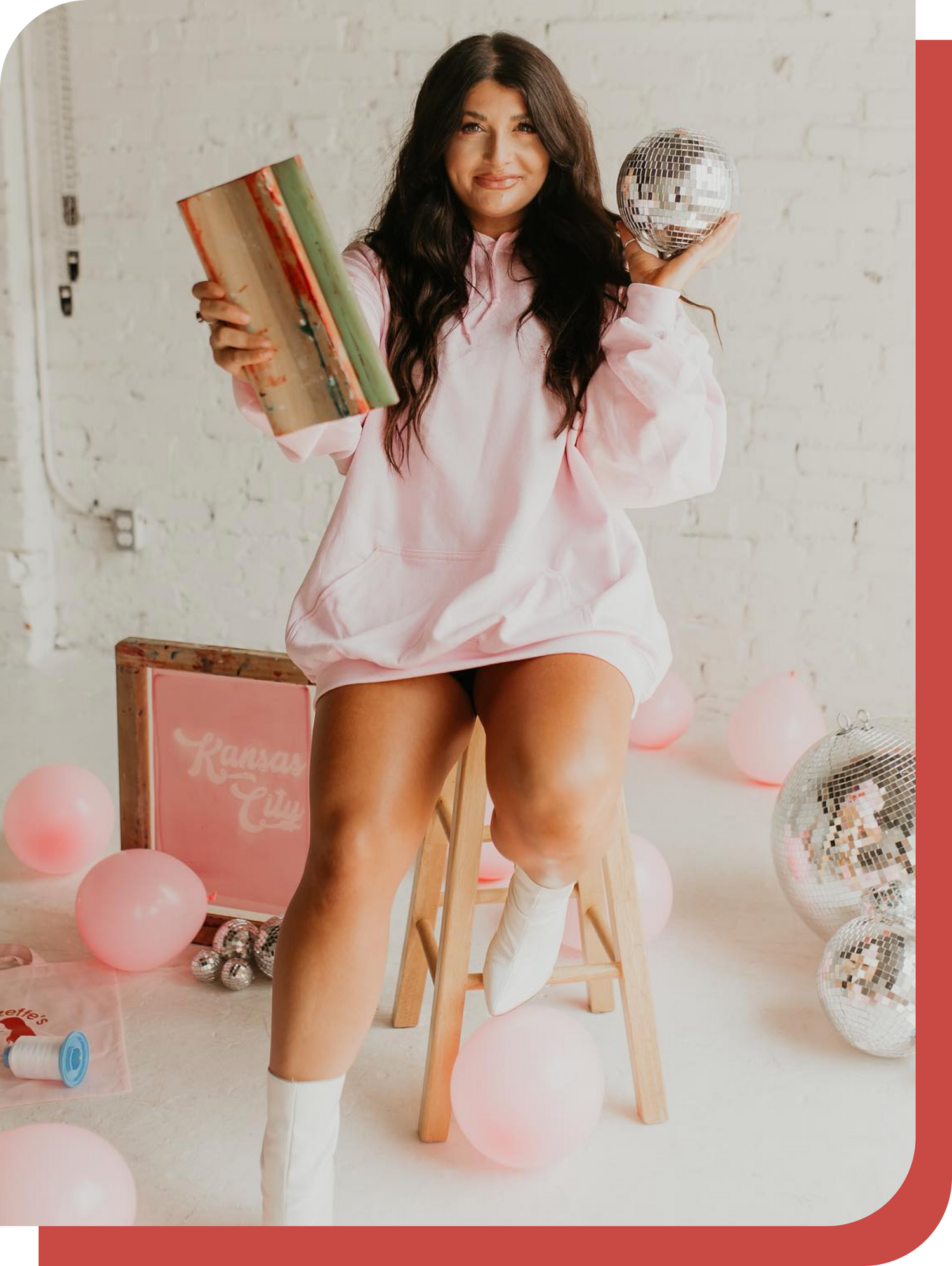 Leanna holding her screen printing device and a disco ball