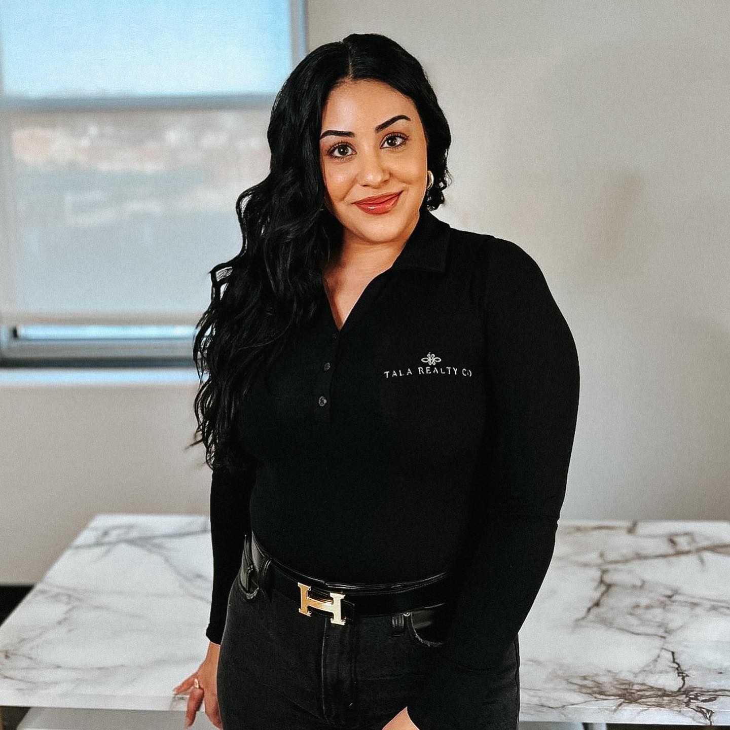 Tala Realty Co embroidery button down shirt modeled by owner